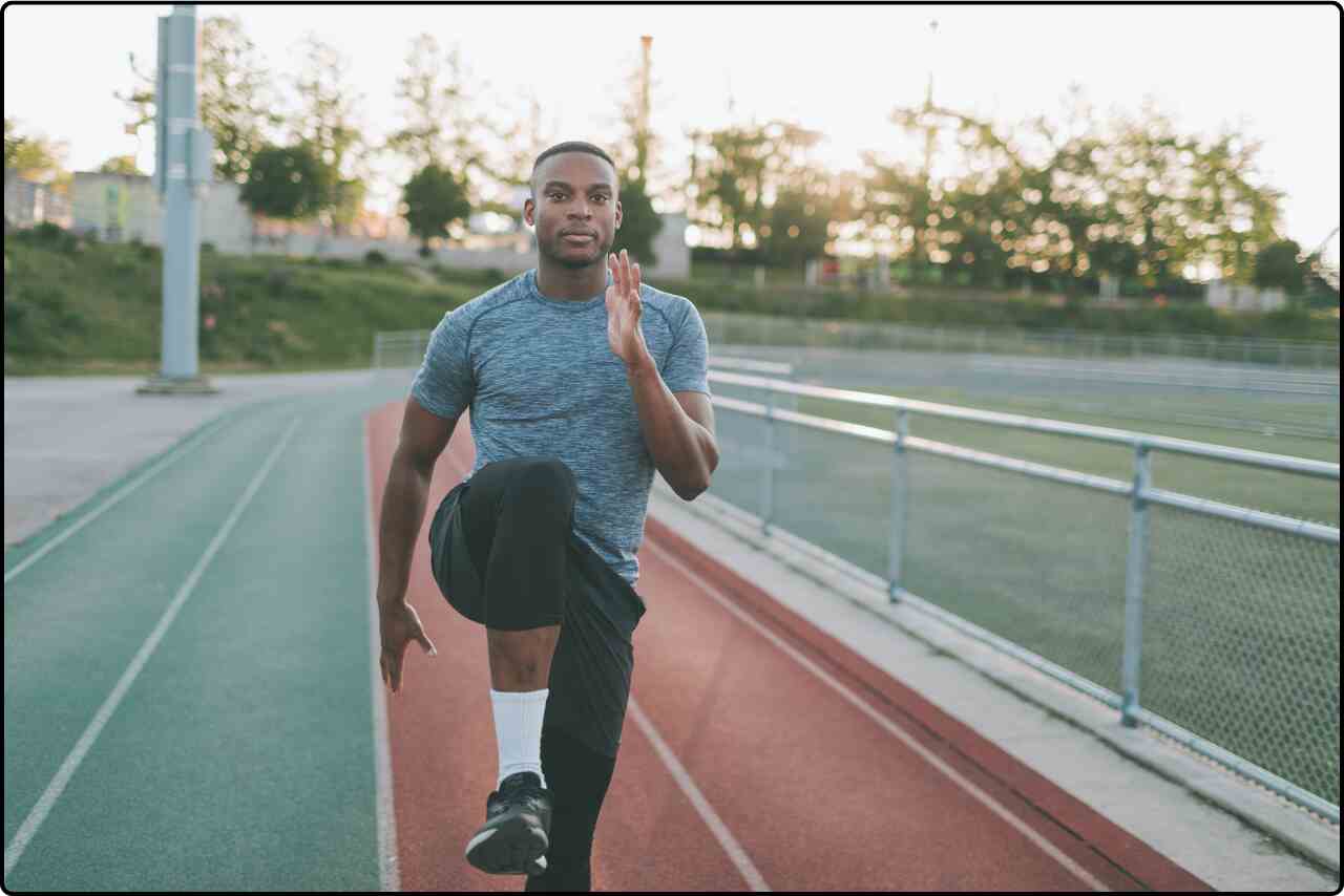 Male athlete performing a workout routine outside.